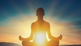 Woman,Young,Person,In,Yoga,Pose,Meditation,At,Sunset.
