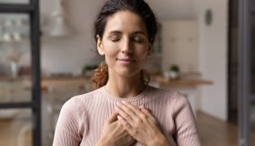 Close,Up,Of,Calm,Young,Caucasian,Woman,Hold,Hands,On